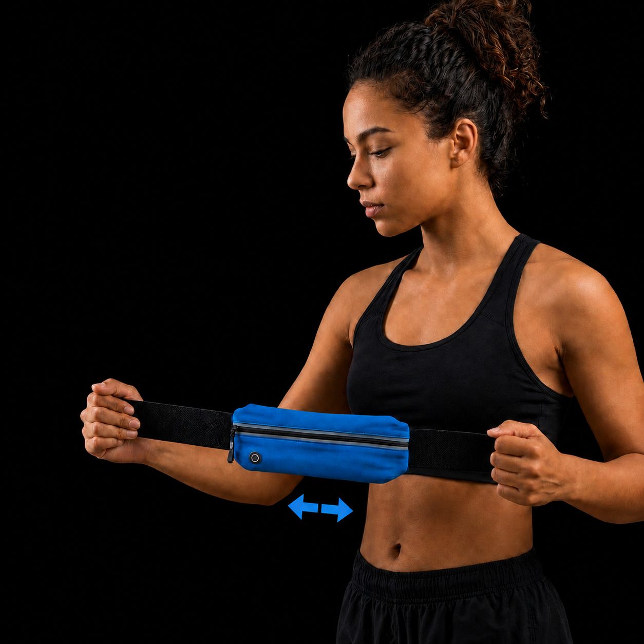 The blue belt held open by hand, showing how far the stretch pocket expands to fit a large phone.